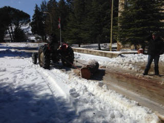 George Shawool Towing the Log with the Tractor 